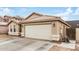 Exterior shot highlighting the two-car garage and desert-style landscaping at 1565 E 10Th St, Casa Grande, AZ 85122