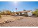 Expansive backyard featuring a covered patio and desert landscaping and rock feature at 15811 N 23Rd St, Phoenix, AZ 85022