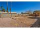 Large backyard with a rock perimeter, cinder block wall, dirt space, and palm trees at 15811 N 23Rd St, Phoenix, AZ 85022