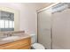 This bathroom features a granite vanity top, white sink, walk-in shower, and a large mirror at 15811 N 23Rd St, Phoenix, AZ 85022