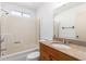 This bathroom includes a granite vanity top, white sink, large mirror, and walk-in shower at 15811 N 23Rd St, Phoenix, AZ 85022