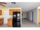 Bright eat-in kitchen features wood cabinetry, black appliances, tile flooring and a neutral color scheme at 15811 N 23Rd St, Phoenix, AZ 85022