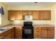 The kitchen features oak cabinets, black appliances, and durable countertops at 15811 N 23Rd St, Phoenix, AZ 85022