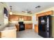 Functional kitchen with oak cabinets, black appliances, and neutral countertops at 15811 N 23Rd St, Phoenix, AZ 85022