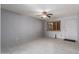 Living room featuring tile flooring, neutral walls, a ceiling fan, and a window with wood shutters at 15811 N 23Rd St, Phoenix, AZ 85022