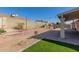 Backyard with string lights, paved patio, and artificial lawn at 1715 N Sawyer --, Mesa, AZ 85207