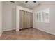 Neutral bedroom featuring a ceiling fan, closet, and a window with plantation shutters at 1715 N Sawyer --, Mesa, AZ 85207