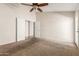 Carpeted bedroom featuring a ceiling fan, and access to the hall at 1715 N Sawyer --, Mesa, AZ 85207