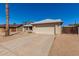 Well-maintained home featuring a two-car garage, desert landscaping, and a concrete driveway at 1715 N Sawyer --, Mesa, AZ 85207