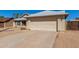 Single-story home with a two-car garage, desert landscaping, and a long concrete driveway at 1715 N Sawyer --, Mesa, AZ 85207