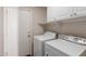 Practical laundry room with washer, dryer, and cabinet storage at 1715 N Sawyer --, Mesa, AZ 85207