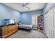 Cozy bedroom with blue walls, carpet flooring, ceiling fan and a window at 17839 W Maui Ln, Surprise, AZ 85388