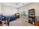 Bright bedroom with neutral walls, a ceiling fan, window, carpet flooring and a guitar at 17839 W Maui Ln, Surprise, AZ 85388