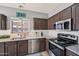 Well-lit kitchen featuring granite countertops, stainless steel appliances, and tiled backsplash at 17839 W Maui Ln, Surprise, AZ 85388