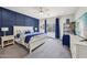 Serene main bedroom with navy accent wall, a plush carpet, and lots of natural light at 17839 W Maui Ln, Surprise, AZ 85388