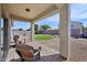 Covered patio overlooking a well-maintained backyard with a turf area and low-maintenance landscaping at 17839 W Maui Ln, Surprise, AZ 85388