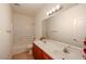 Bathroom featuring double sinks, wood cabinets, and a shower-tub combo at 1835 W Minton St, Phoenix, AZ 85041