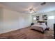 Bright bedroom features a ceiling fan, neutral paint and carpet, and natural light from the window at 1835 W Minton St, Phoenix, AZ 85041