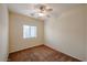 Cozy bedroom with ceiling fan, neutral paint and carpet, and natural light from the window at 1835 W Minton St, Phoenix, AZ 85041