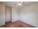 A carpeted bedroom with a ceiling fan and white closet door at 1835 W Minton St, Phoenix, AZ 85041