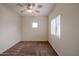 Bedroom featuring a ceiling fan, neutral paint and carpet, and natural light from two windows at 1835 W Minton St, Phoenix, AZ 85041