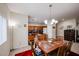 Open-concept dining area with a wooden table, chairs, and view of the kitchen at 1835 W Minton St, Phoenix, AZ 85041