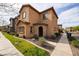 Charming two-story home with neutral stucco, red shutters, stone archway entrance, and fresh landscaping at 1835 W Minton St, Phoenix, AZ 85041