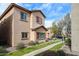 Two-story home with colorful red shutters and well-manicured front lawn and manicured bushes at 1835 W Minton St, Phoenix, AZ 85041