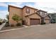 Attached two-car garage with decorative brown door, stucco exterior, and well-maintained landscaping at 1835 W Minton St, Phoenix, AZ 85041