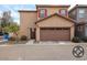 Attached two-car garage with decorative brown door, stucco exterior, and fresh landscaping at 1835 W Minton St, Phoenix, AZ 85041