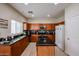 Modern kitchen with dark countertops, stainless steel appliances, and sleek cabinets at 1835 W Minton St, Phoenix, AZ 85041