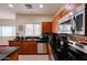 Close-up of a kitchen area featuring stainless steel appliances and dark granite countertops at 1835 W Minton St, Phoenix, AZ 85041