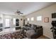 Bright living room boasts tiled floors, neutral walls, a ceiling fan, and a cozy sectional couch at 1835 W Minton St, Phoenix, AZ 85041