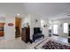 Open-concept living room with tile floors, neutral walls, staircase, tv, and access to the kitchen at 1835 W Minton St, Phoenix, AZ 85041