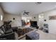 Bright living room boasts tiled floors, neutral walls, ceiling fan, and seamless flow to kitchen at 1835 W Minton St, Phoenix, AZ 85041