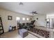 Spacious living room showcases tile flooring, neutral walls, ceiling fan, and access to dining area at 1835 W Minton St, Phoenix, AZ 85041