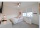 A cozy bedroom features carpet, a ceiling fan, and natural light creating a relaxing and inviting space at 1901 W 23Rd Ave, Apache Junction, AZ 85120