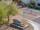 Bella Corona community entrance sign with brick paved street and black metal gate in the background at 1901 W 23Rd Ave, Apache Junction, AZ 85120