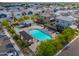 Aerial view of a community pool with seating, shade structures, and a hot tub at 1901 W 23Rd Ave, Apache Junction, AZ 85120