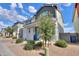 Inviting front exterior boasts a blue front door, a charming tree, and desert-friendly landscaping at 1901 W 23Rd Ave, Apache Junction, AZ 85120