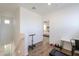 Open hallway with wood-look floors and a view into another bedroom at 1901 W 23Rd Ave, Apache Junction, AZ 85120