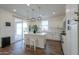 Stylish kitchen features a central island with stools, white cabinets, stainless appliances, and sliding glass doors at 1901 W 23Rd Ave, Apache Junction, AZ 85120