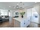 Modern kitchen with a center island, white cabinets, pendant lighting, and open access to the living room at 1901 W 23Rd Ave, Apache Junction, AZ 85120