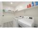 Well-organized laundry room with modern appliances and stylish patterned floors at 1901 W 23Rd Ave, Apache Junction, AZ 85120