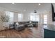 Spacious living room with wood-look tile flooring, recessed lighting, and a comfortable gray sofa at 1901 W 23Rd Ave, Apache Junction, AZ 85120