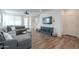 Comfortable living room showcasing a gray sectional sofa, stylish decor, and wood-look tile flooring at 1901 W 23Rd Ave, Apache Junction, AZ 85120