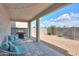 Outdoor patio area with wicker chairs, a gas grill, and gravel landscaping at 1901 W 23Rd Ave, Apache Junction, AZ 85120