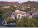 Beautiful aerial view of a luxury home featuring mountain views, lush landscaping at 20299 N 102Nd Pl, Scottsdale, AZ 85255