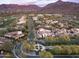 Expansive aerial view of a neighborhood showcasing well-manicured lawns, mountains and a golf course at 20299 N 102Nd Pl, Scottsdale, AZ 85255