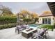 Gorgeous backyard featuring a shimmering pool, inviting fire pit, and well-manicured landscaping for serene relaxation at 20299 N 102Nd Pl, Scottsdale, AZ 85255